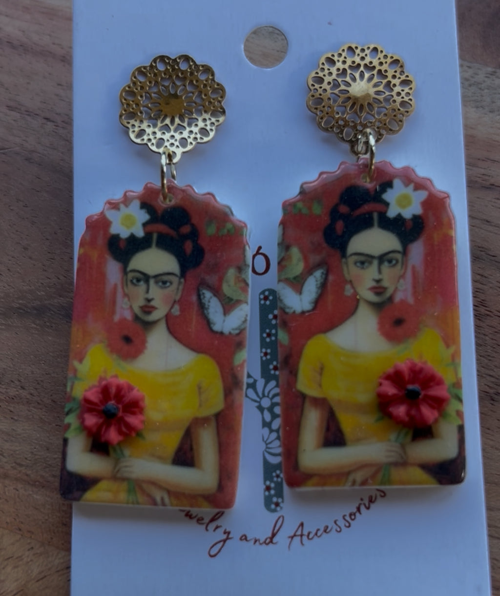 Frida Kahlo-themed earrings on a backing card.